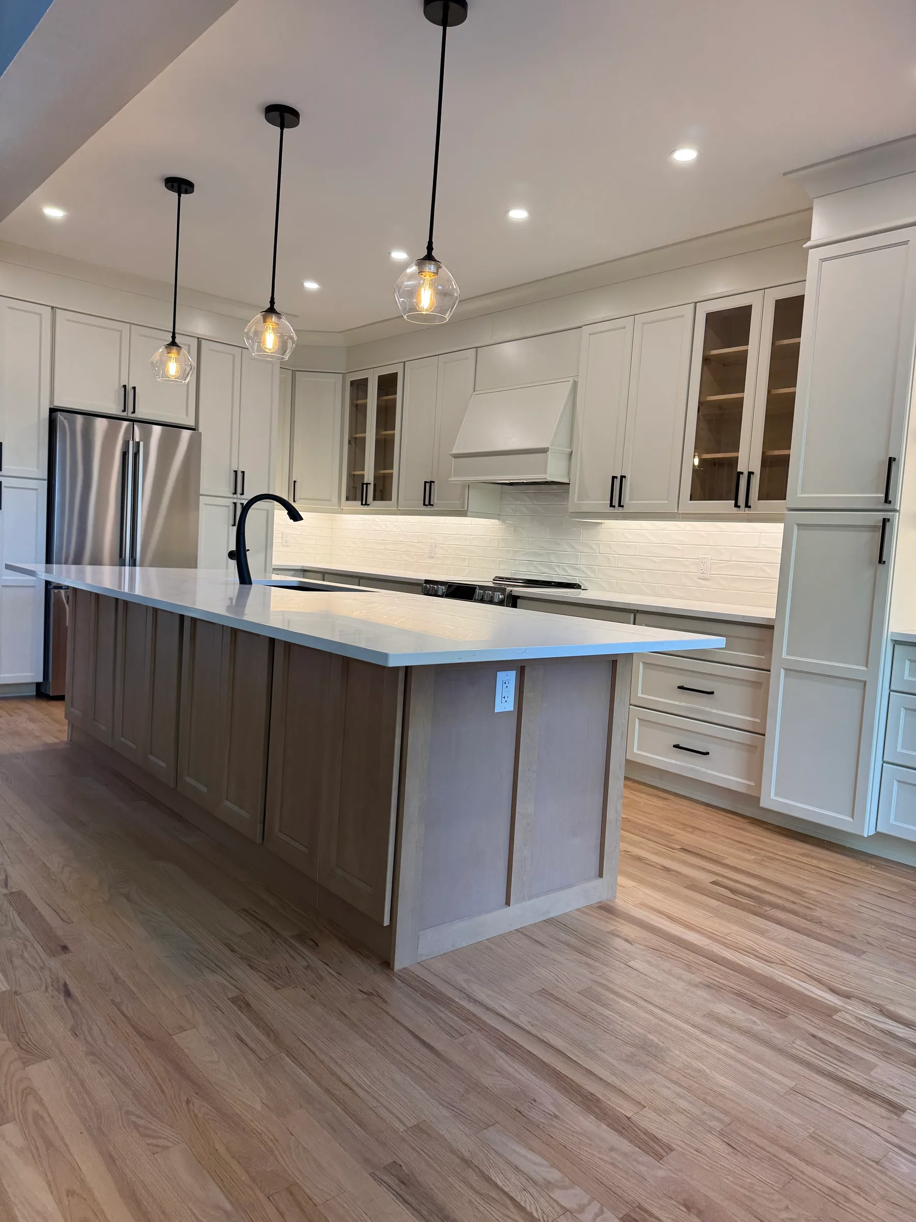 Full kitchen view with island and refinished hardwood flooring, Greely