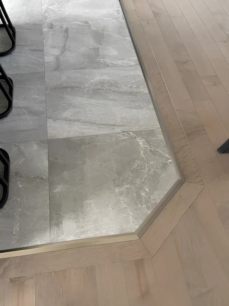 Mitred tile-to-hardwood floor transition with metal edge trim, Ottawa
