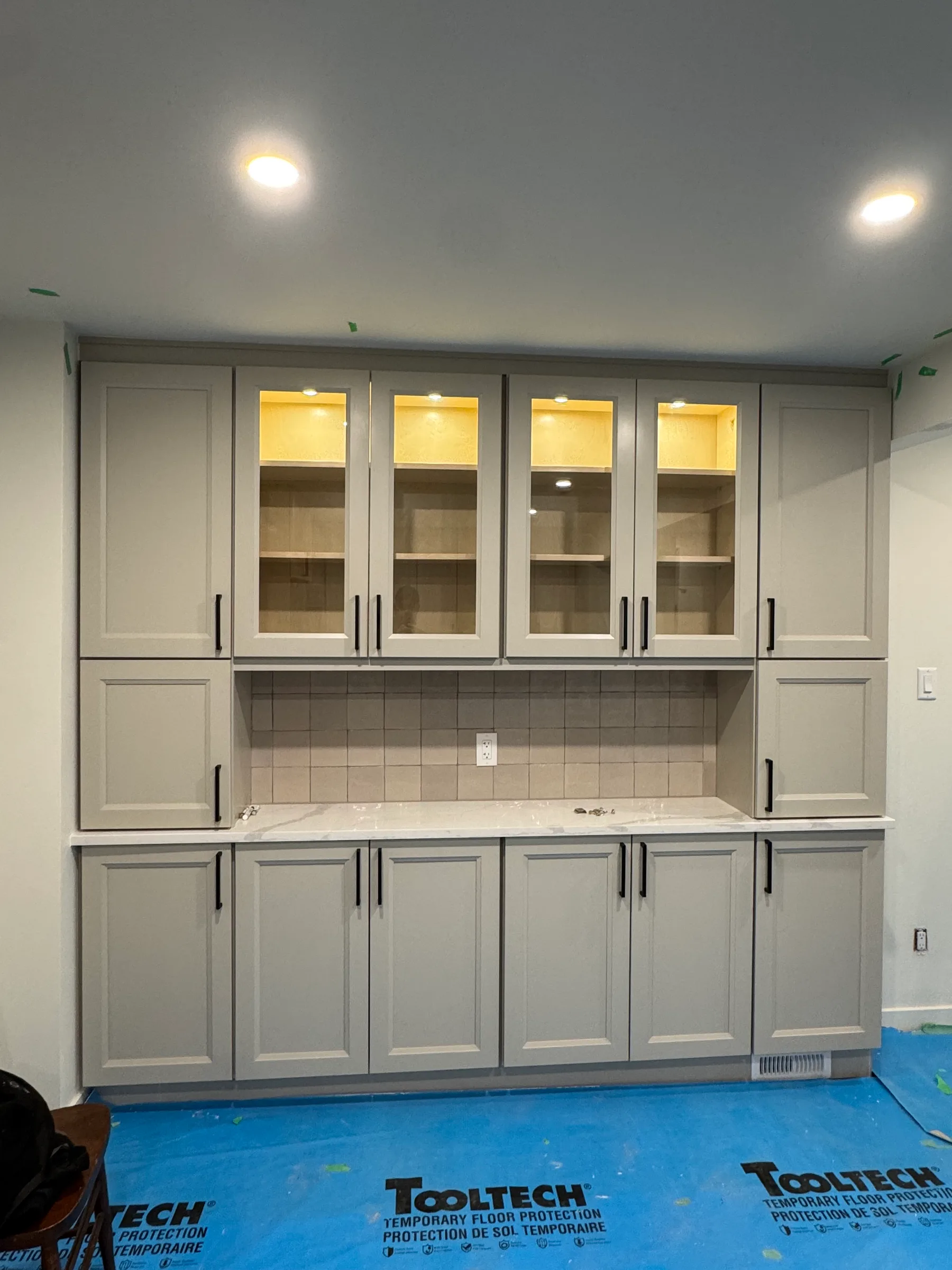Tall built-in display cabinets with lit glass fronts, Kanata townhouse